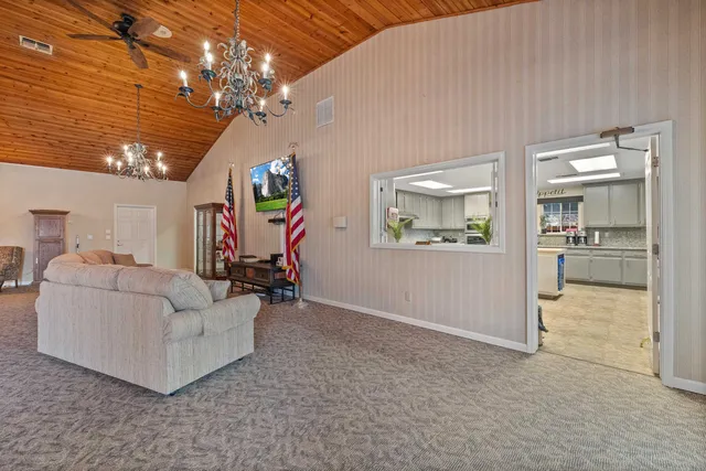 a living room with furniture and a chandelier