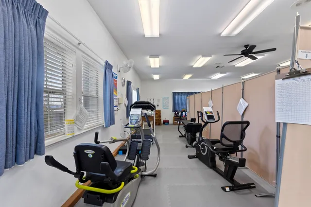 a room with gym equipment and windows