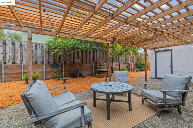 a outdoor space with the couches and dining table with wooden floor