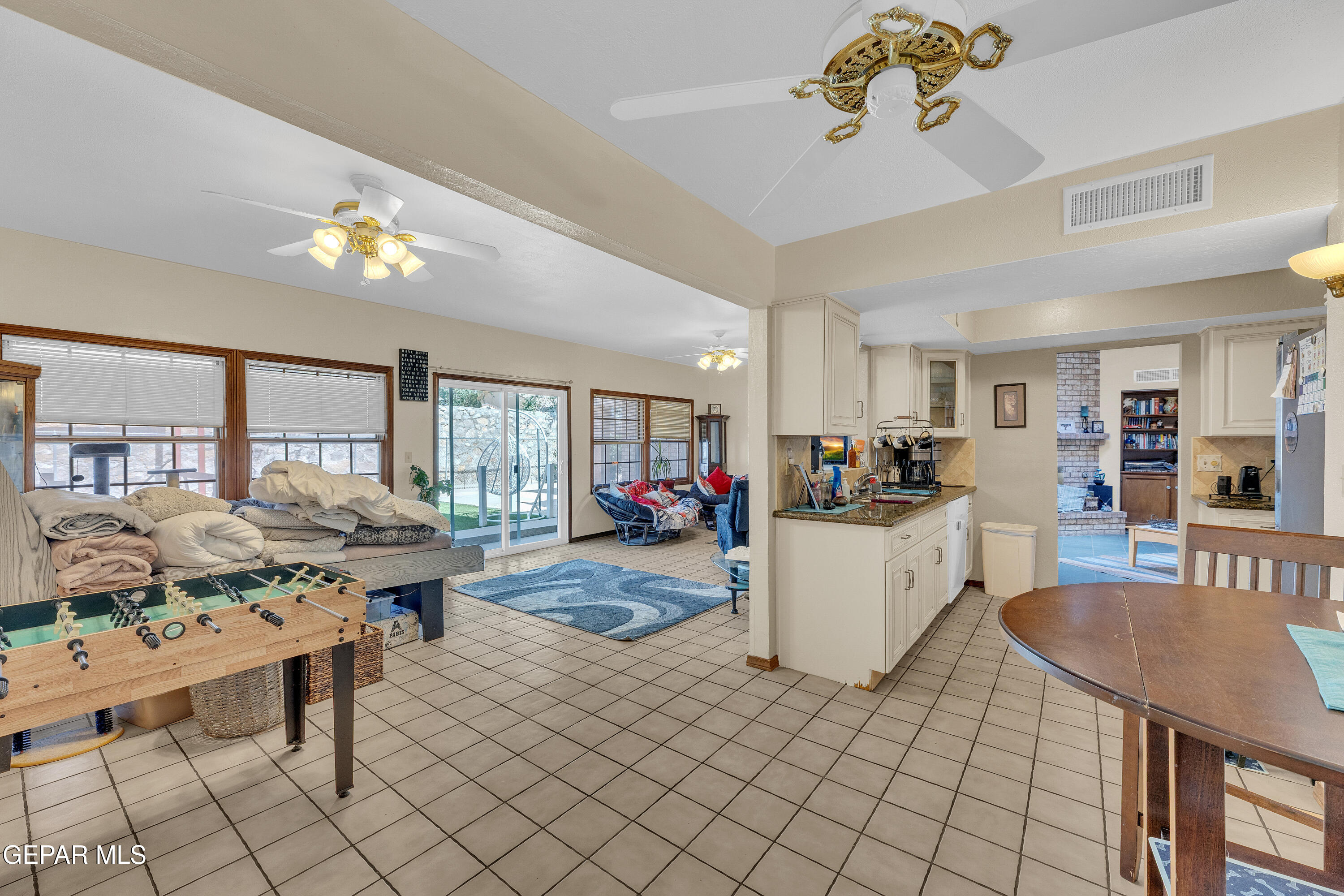 1664 Dick Ritter Street El Paso, TX 79936 - Photo 18 of 65 a living room with furniture and a dining table with kitchen view
