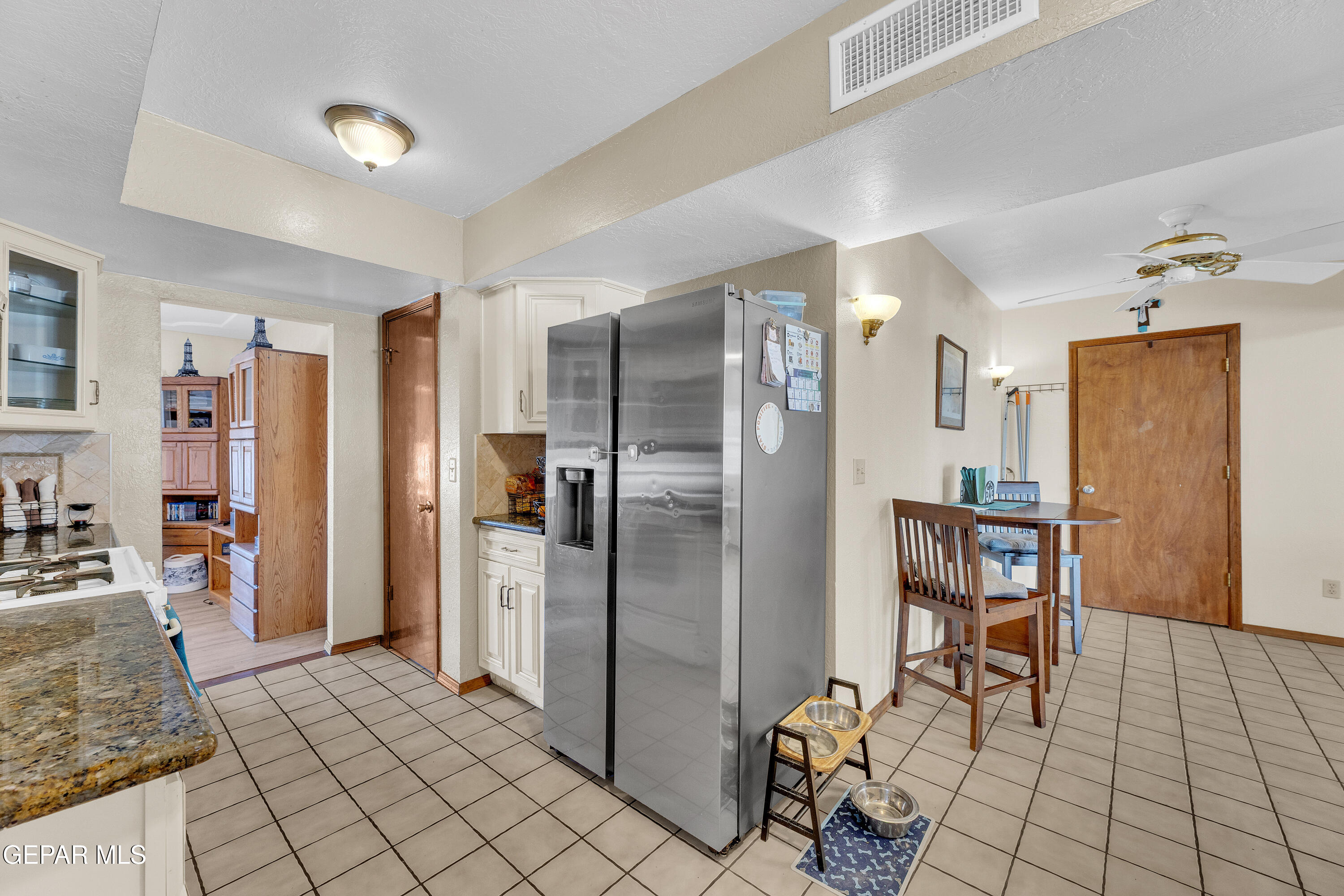 1664 Dick Ritter Street El Paso, TX 79936 - Photo 23 of 65 a kitchen with stainless steel appliances granite countertop a refrigerator and a stove top oven