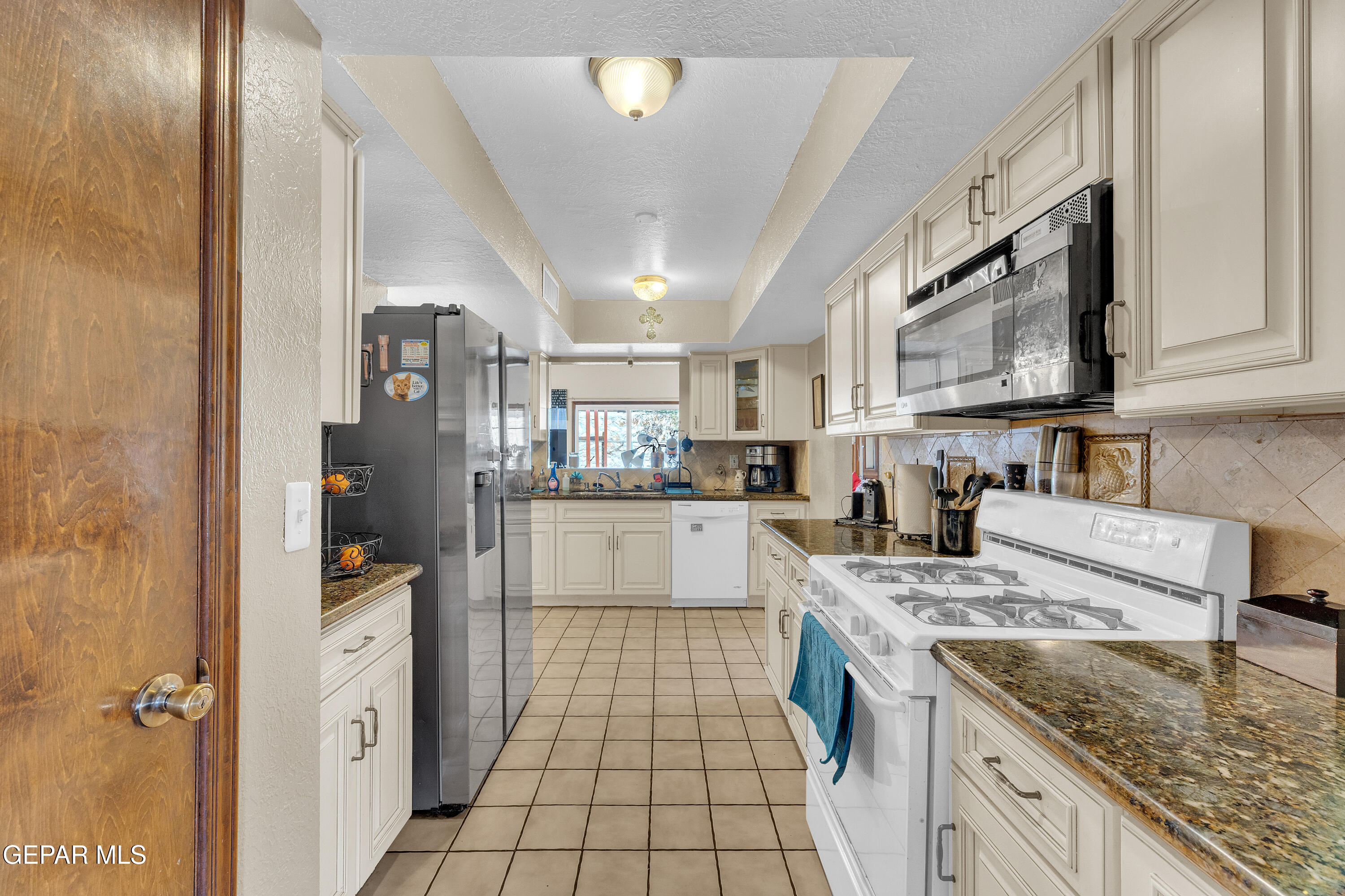 1664 Dick Ritter Street El Paso, TX 79936 - Photo 24 of 65 a kitchen with stainless steel appliances granite countertop a sink and cabinets