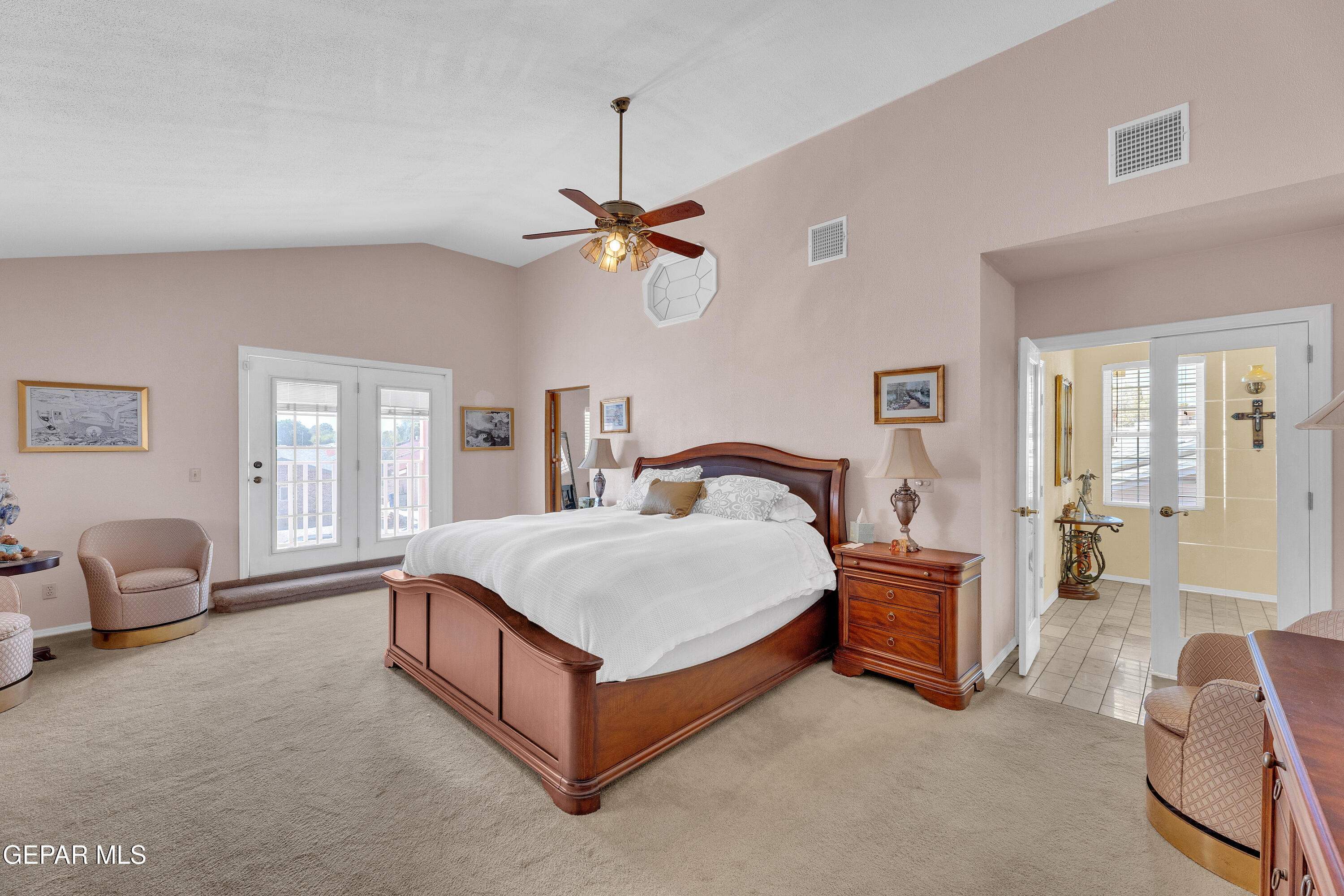 1664 Dick Ritter Street El Paso, TX 79936 - Photo 49 of 65 a spacious bedroom with a bed a chandelier and a couch