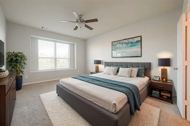 an empty room with a window and a fan