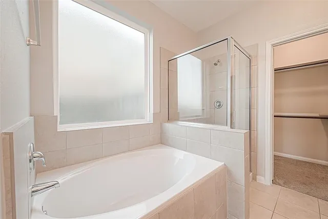 a white bath tub sitting next to a window