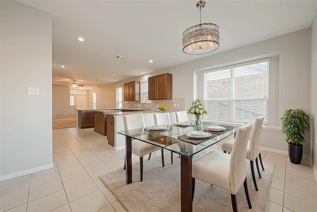a large white kitchen with granite countertop a sink and a granite counter top