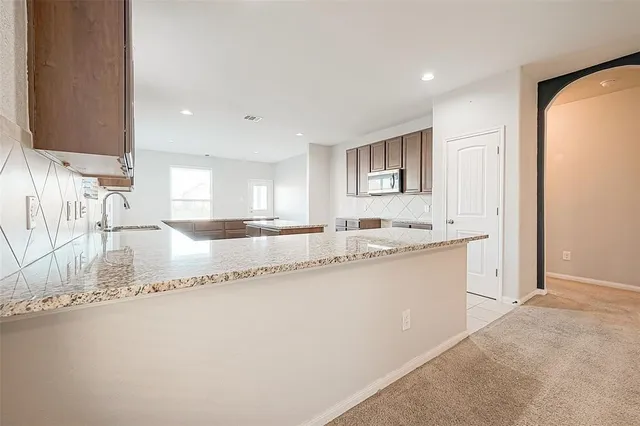 a kitchen with a sink cabinets and window