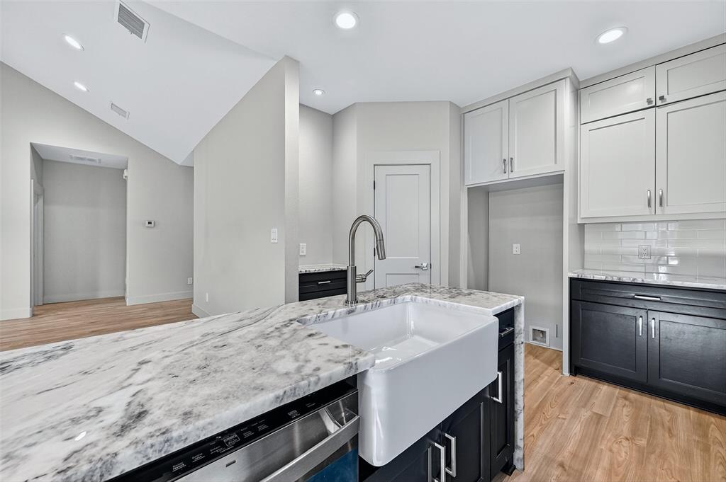4805 Dry Creek Road Sherman, TX 75092 - Photo 12 of 29 a kitchen with granite countertop a sink stove and refrigerator