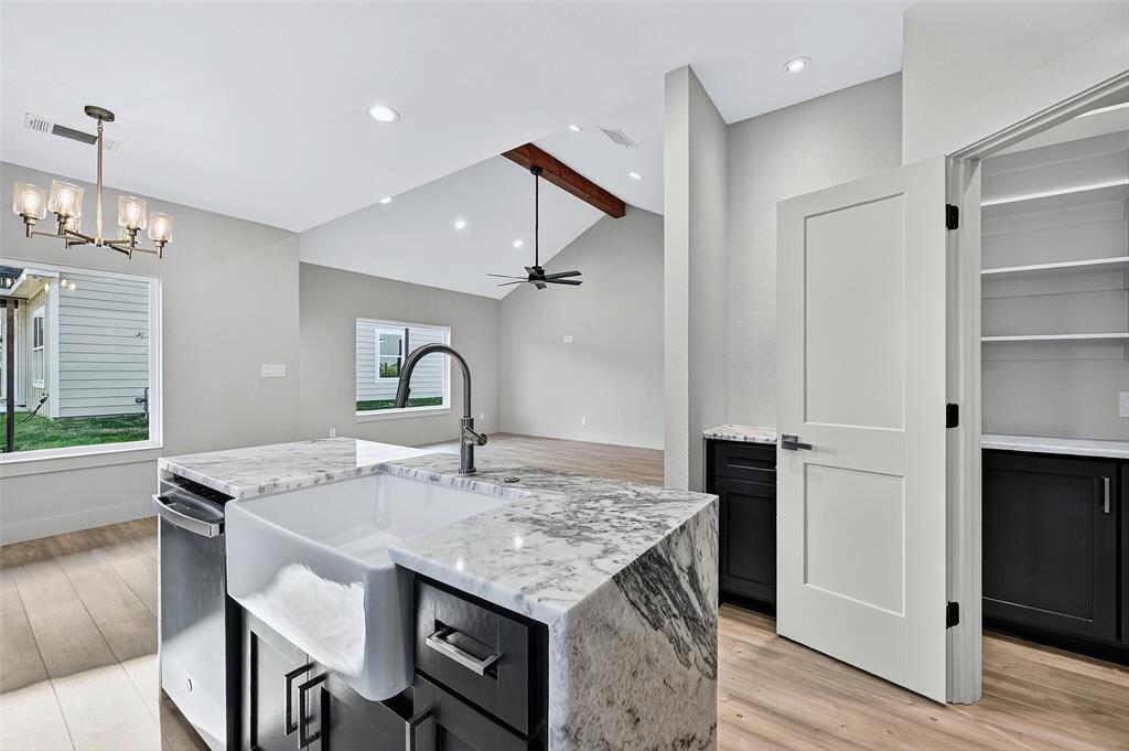 4805 Dry Creek Road Sherman, TX 75092 - Photo 13 of 29 a view of kitchen island with stainless steel appliances granite countertop stove top oven and couches