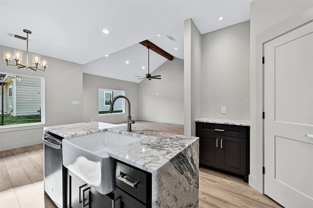 4805 Dry Creek Road Sherman, TX 75092 - Photo 14 of 29 a kitchen with a kitchen island a stove a table and chairs