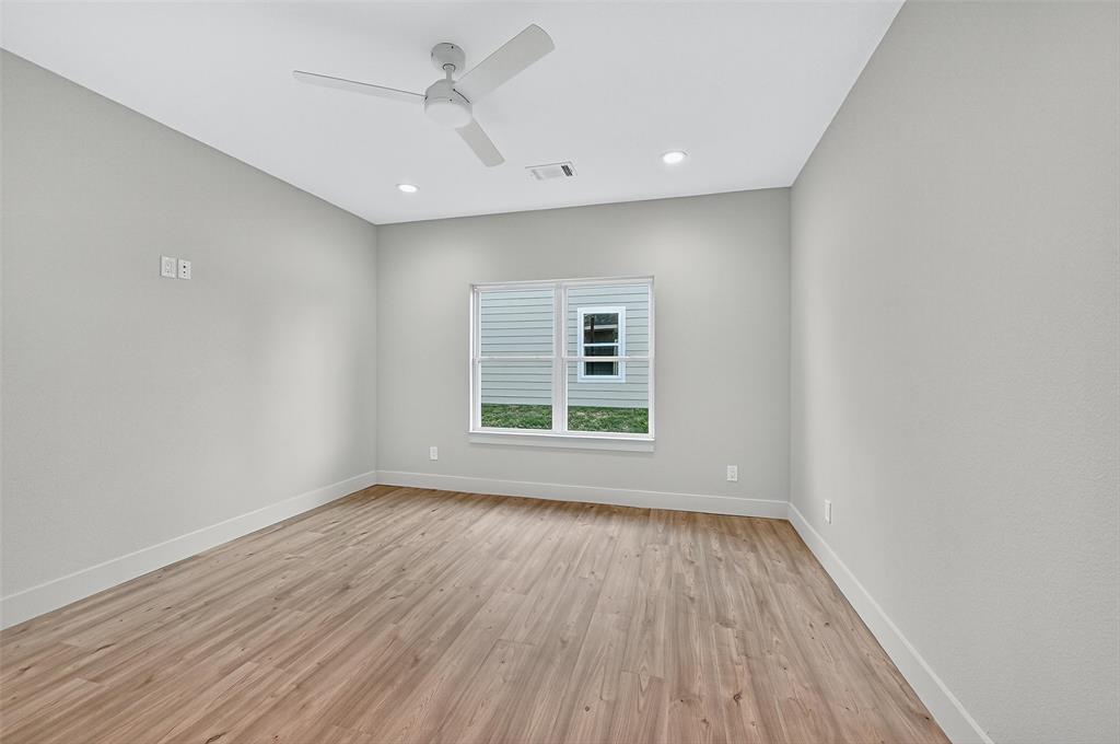 4805 Dry Creek Road Sherman, TX 75092 - Photo 17 of 29 a view of empty room with wooden floor and fan
