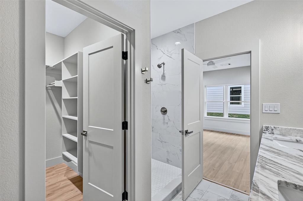 4805 Dry Creek Road Sherman, TX 75092 - Photo 18 of 29 a bathroom with a shower and a glass door