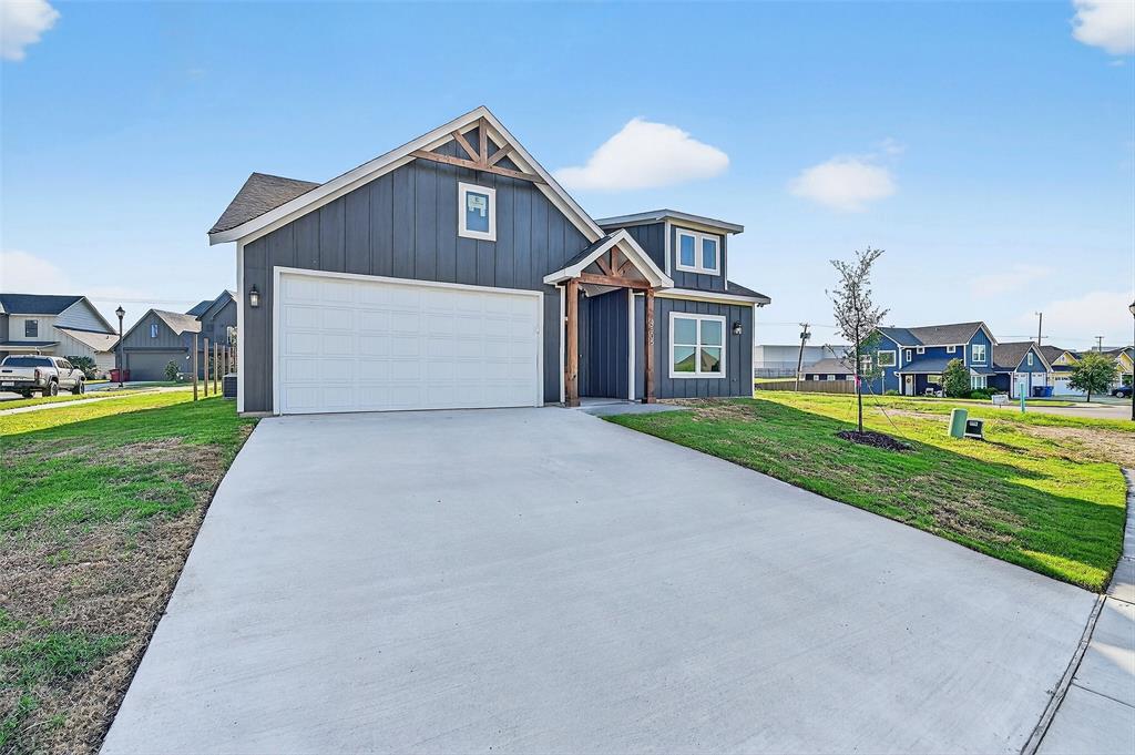 4805 Dry Creek Road Sherman, TX 75092 - Photo 2 of 29 a front view of a house with a yard and garage
