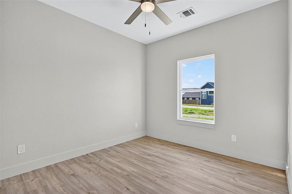 4805 Dry Creek Road Sherman, TX 75092 - Photo 26 of 29 wooden floor in an empty room with a window