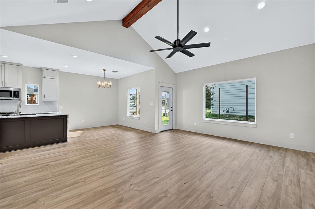 4805 Dry Creek Road Sherman, TX 75092 - Photo 6 of 29 a view of an empty room with wooden floor and a window