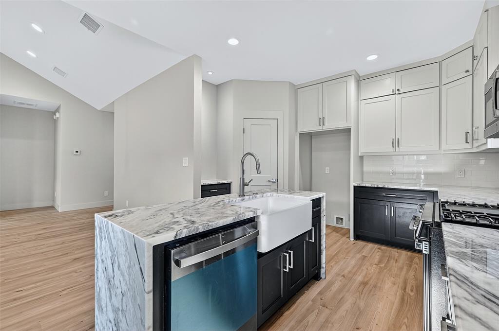 4805 Dry Creek Road Sherman, TX 75092 - Photo 9 of 29 a kitchen with granite countertop a sink stove and refrigerator