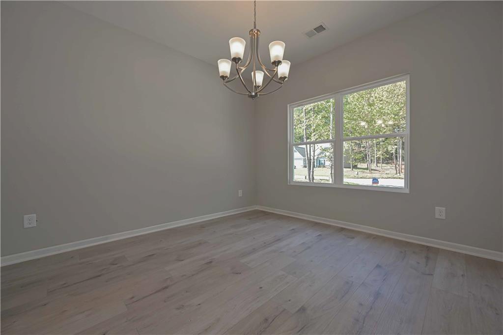 448 The Boulevard Newnan, GA 30263 - Photo 12 of 39 an empty room with wooden floor and windows