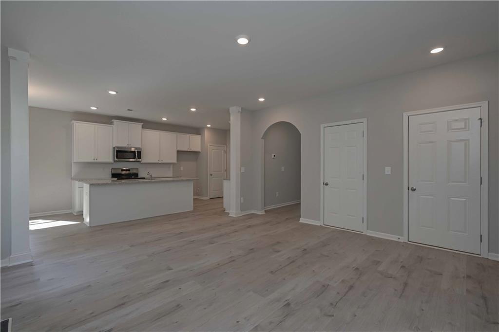 448 The Boulevard Newnan, GA 30263 - Photo 14 of 39 a view of kitchen with refrigerator and white stove top oven