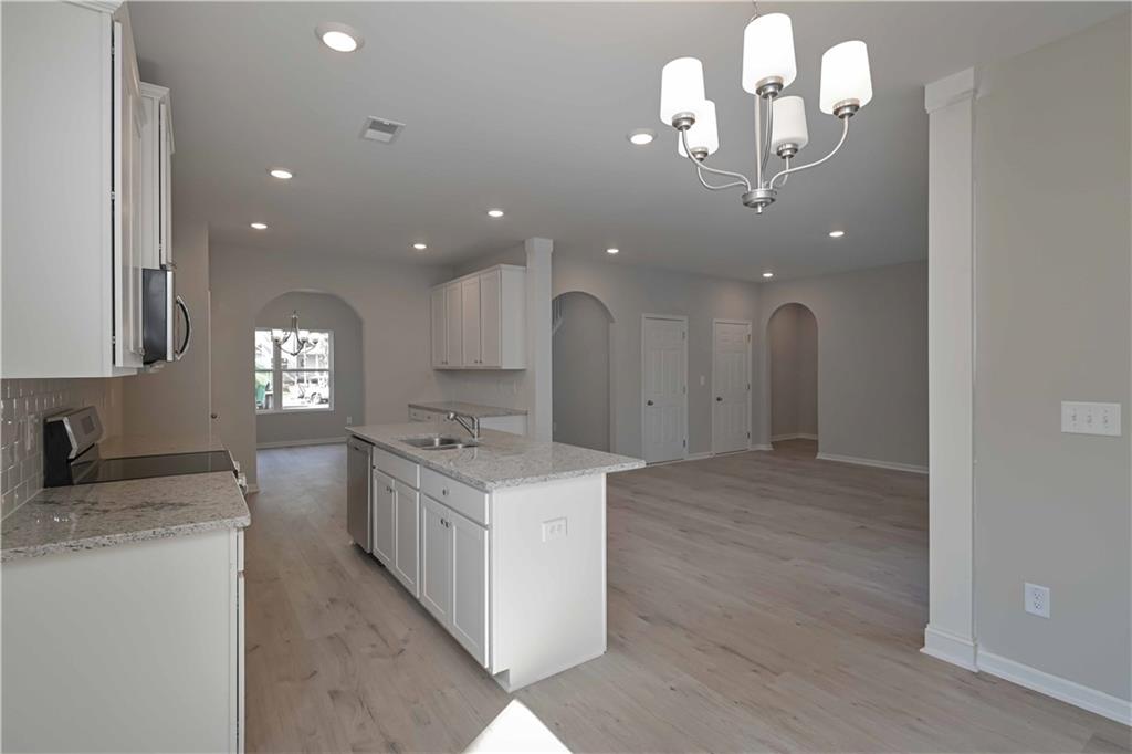 448 The Boulevard Newnan, GA 30263 - Photo 18 of 39 a spacious bathroom with a granite countertop sink a light fixture and a fireplace