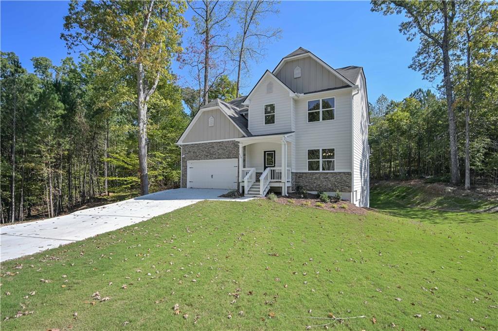 448 The Boulevard Newnan, GA 30263 - Photo 2 of 39 a front view of a house with a yard and garage