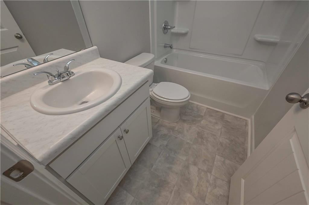 448 The Boulevard Newnan, GA 30263 - Photo 21 of 39 a bathroom with a sink a toilet and bathtub
