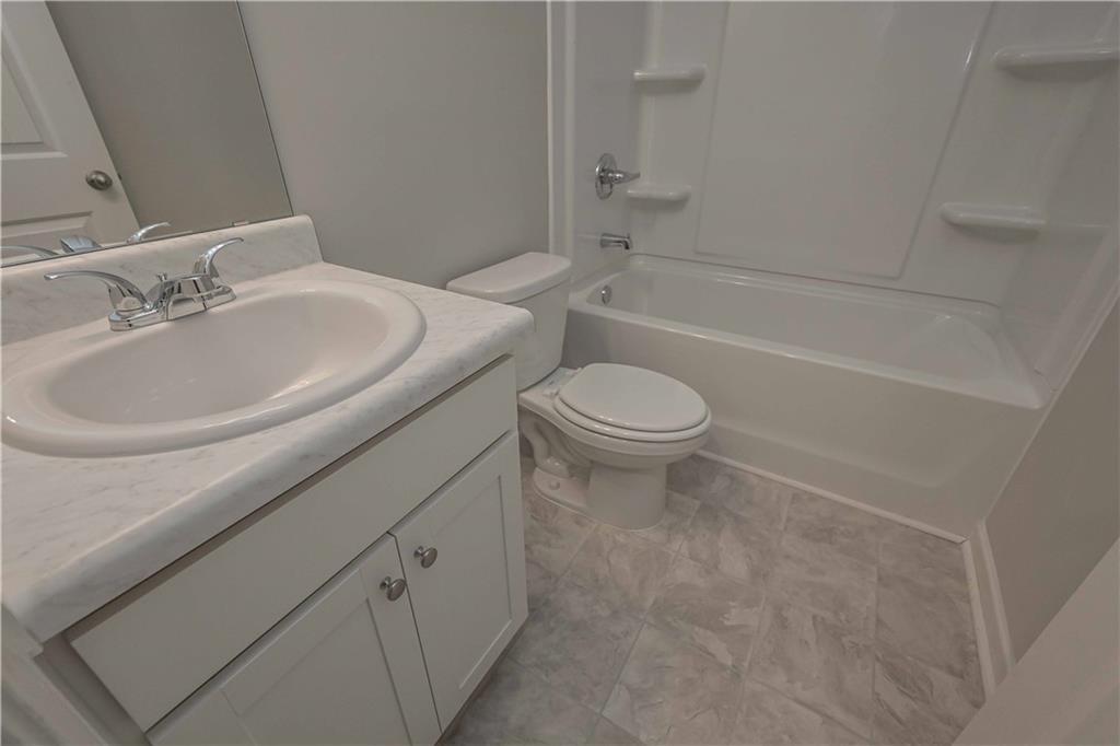 448 The Boulevard Newnan, GA 30263 - Photo 26 of 39 a bathroom with a sink a toilet and a bathtub