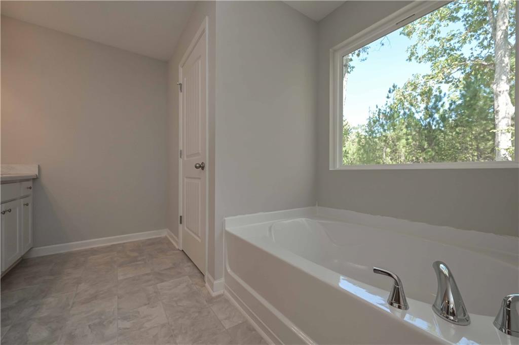 448 The Boulevard Newnan, GA 30263 - Photo 32 of 39 a white bath tub sitting next to a window
