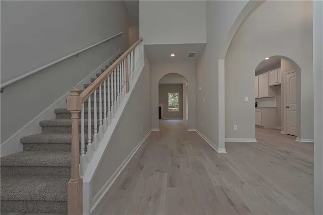 a view of empty room with a fireplace and wooden floor