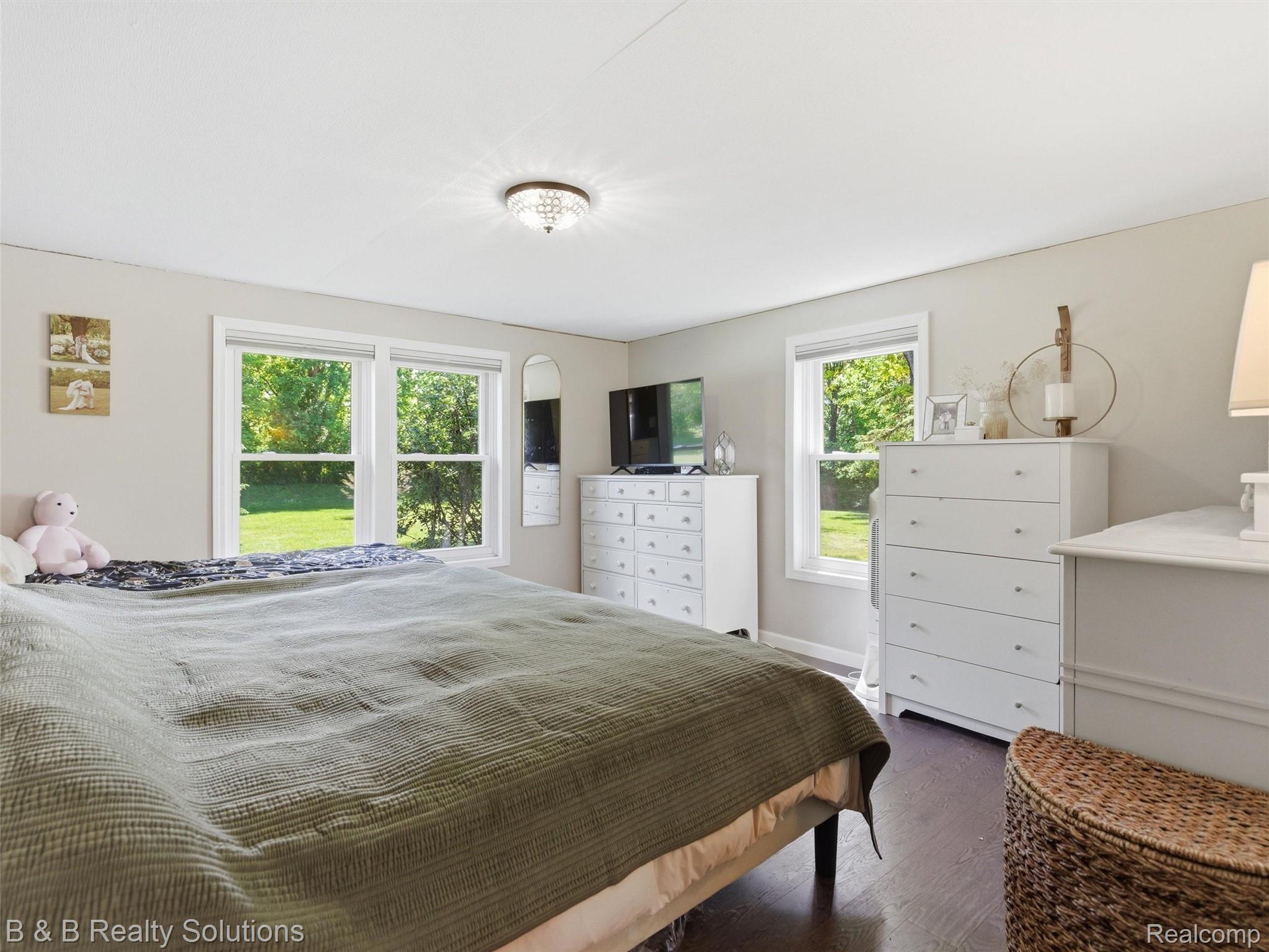 60455 Bates Road New Haven, MI 48048 - Photo 52 of 58 Spacious room featuring wood-finish flooring, light grey walls, and white trim