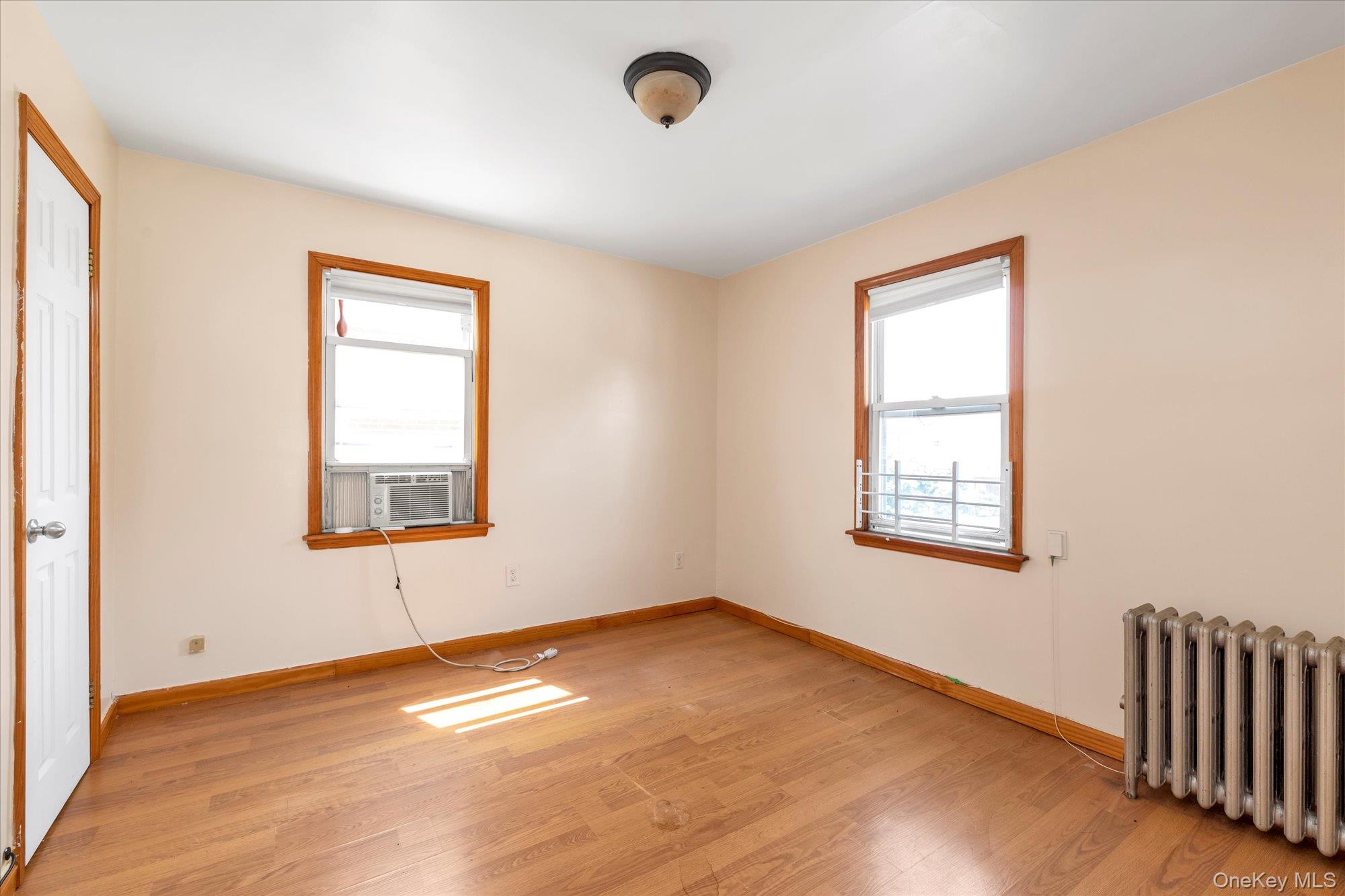 48-18 202nd Street Queens, NY 11364 - Photo 14 of 23 an empty room with a window