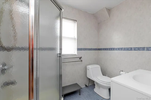 a white toilet sitting next to a bathroom sink