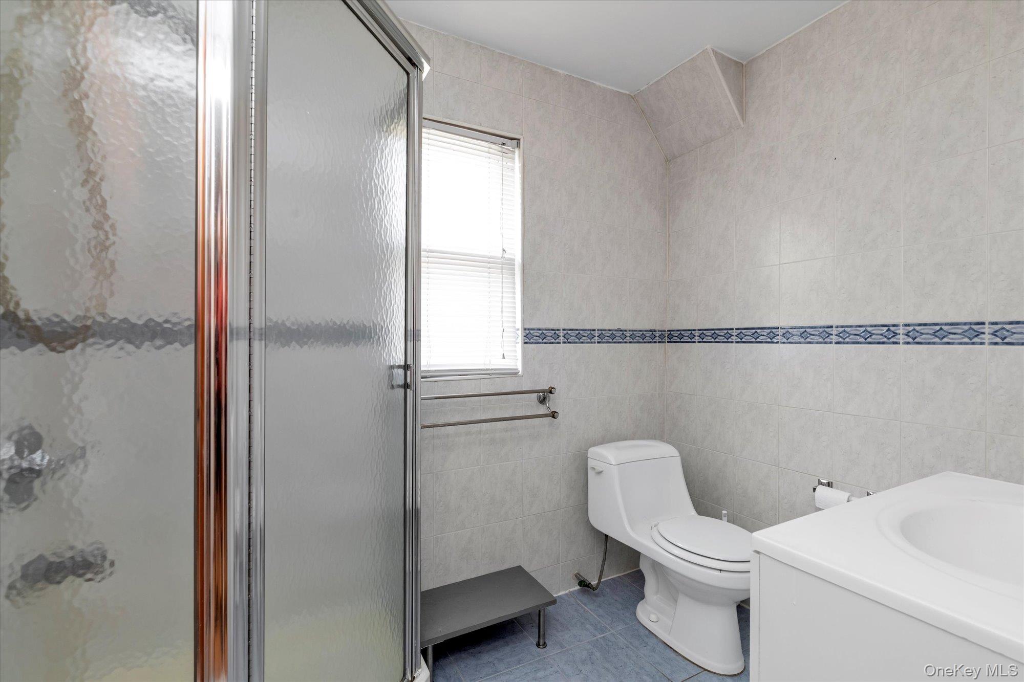 48-18 202nd Street Queens, NY 11364 - Photo 15 of 23 a white toilet sitting next to a bathroom sink