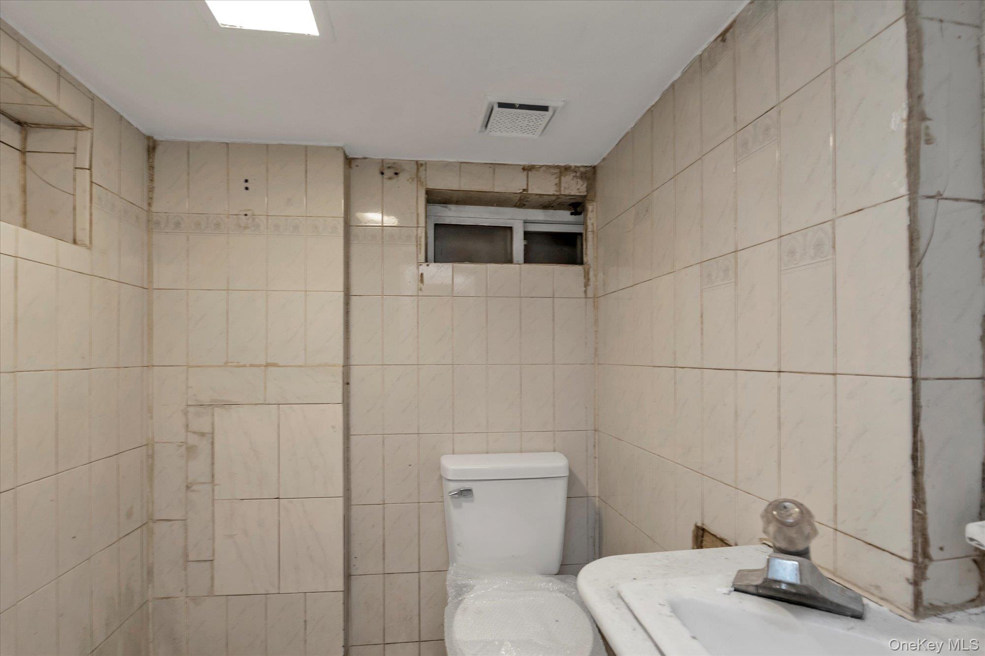 48-18 202nd Street Queens, NY 11364 - Photo 21 of 23 a bathroom with a sink and toilet