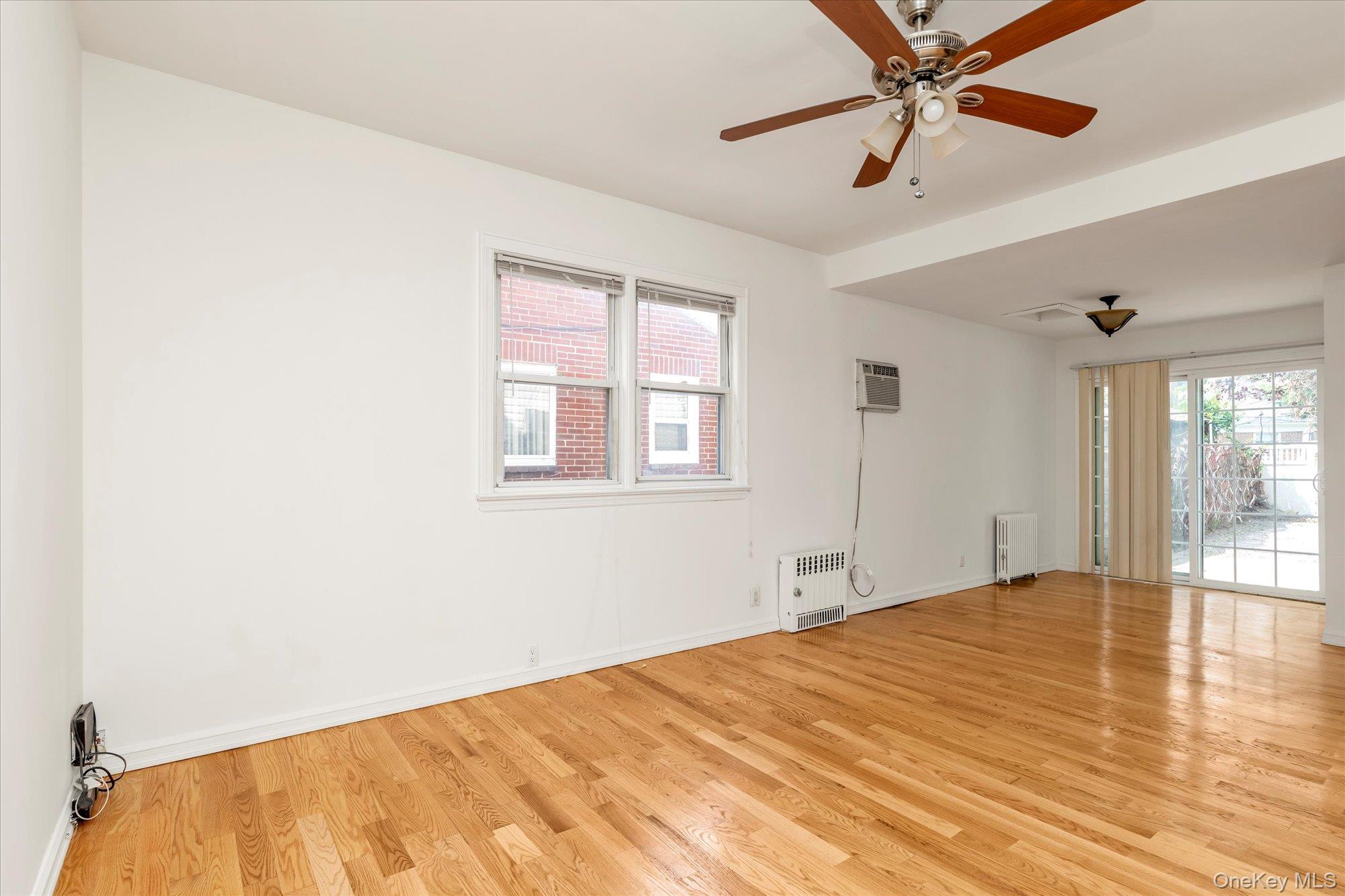 48-18 202nd Street Queens, NY 11364 - Photo 4 of 23 a bedroom with a bed and a chandelier