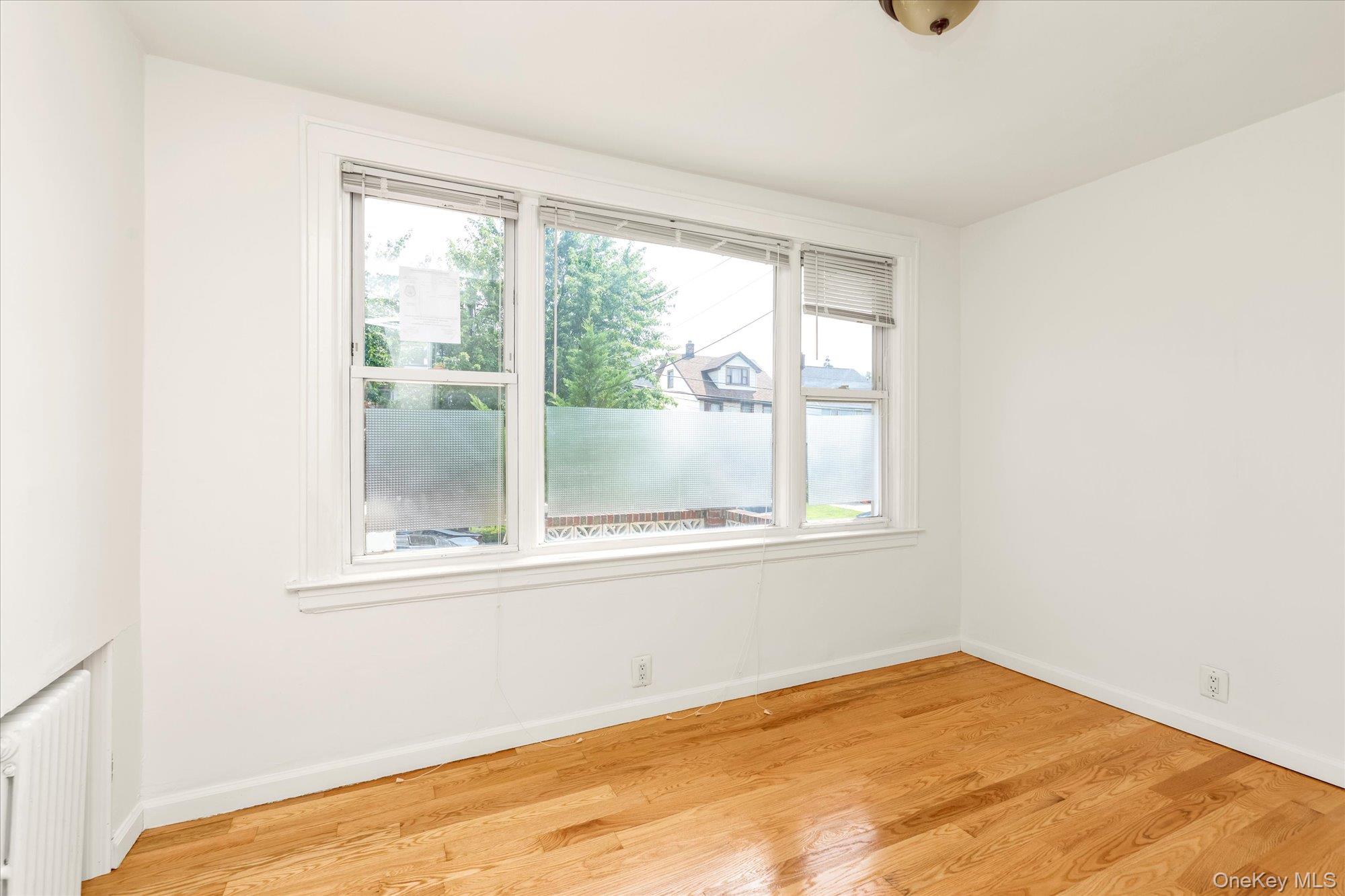 48-18 202nd Street Queens, NY 11364 - Photo 9 of 23 an empty room with a window