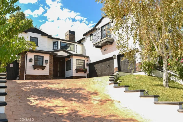 a view of a house with a yard covered in snow