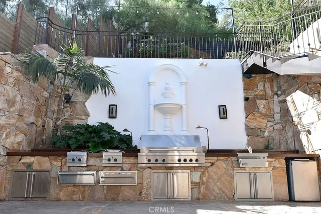 a view of a patio with table and chairs with wooden fence and plants