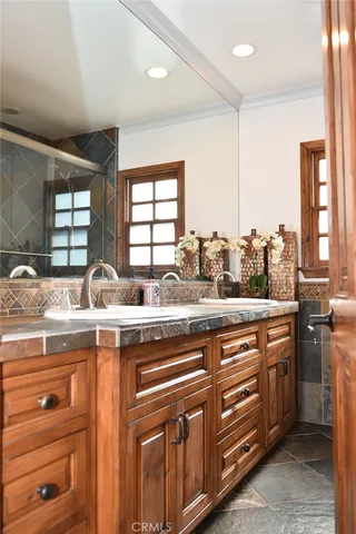a kitchen with stainless steel appliances granite countertop a sink a stove and a wooden cabinets