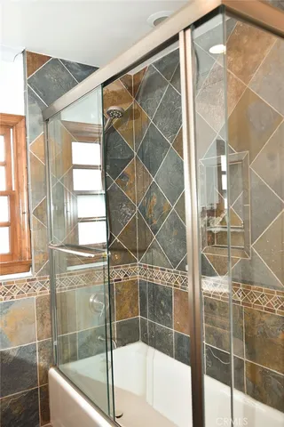a bathroom with a bathtub and shower