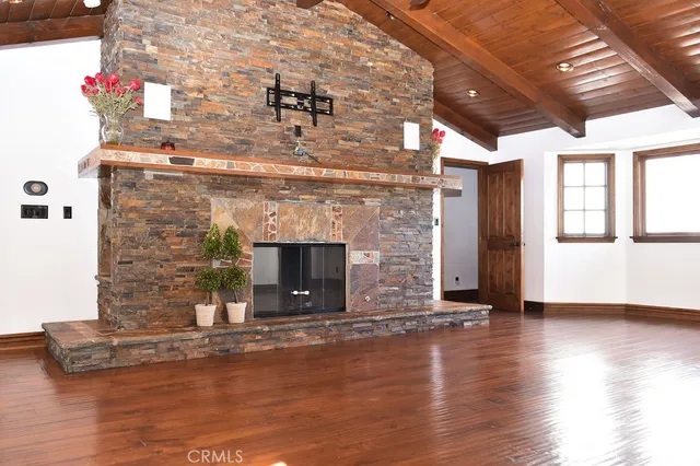 a living room with fireplace and wooden floor