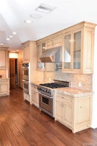 a kitchen with stainless steel appliances granite countertop a stove and a refrigerator
