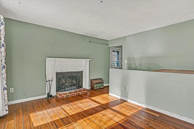 a room with a fireplace and a rug