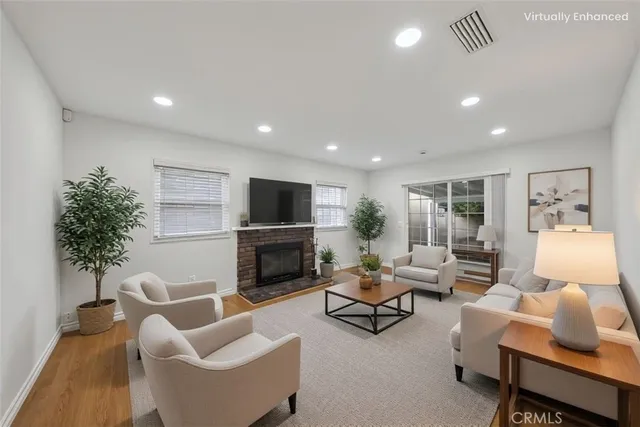 a living room with furniture fireplace and potted plant