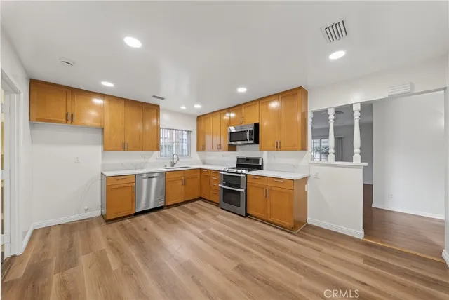 a large kitchen with a lot of counter space and stainless steel appliances