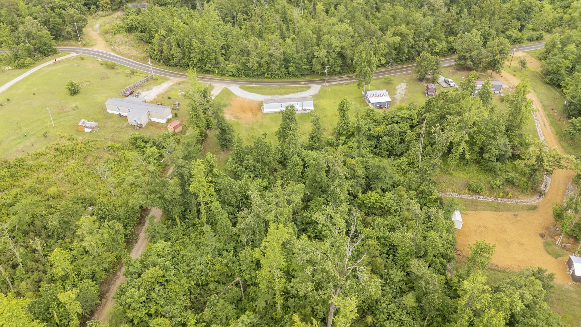 3275 Glendale Road Adamsville, TN 38310 - Photo 12 of 39 a view of a swimming pool with a yard and large trees