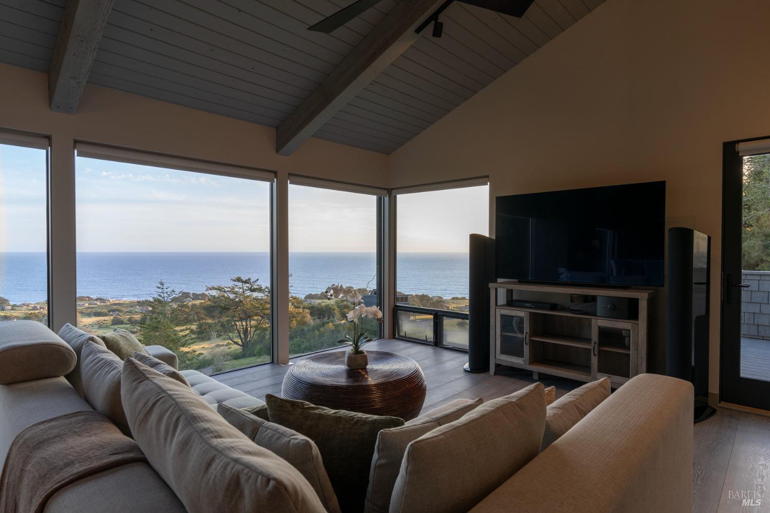 Undisclosed Address The Sea Ranch, CA 95497 - Photo 19 of 46 a living room with couches tv and a floor to ceiling window