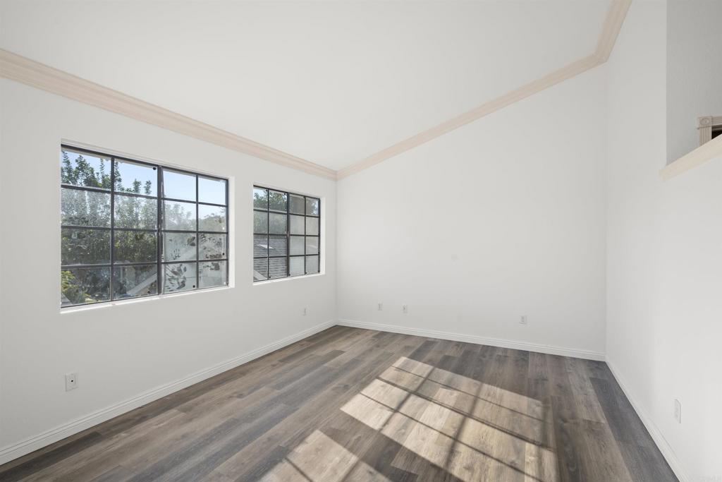 421 Windjammer Circle Chula Vista, CA 91910 - Photo 2 of 17 an empty room with wooden floor and windows