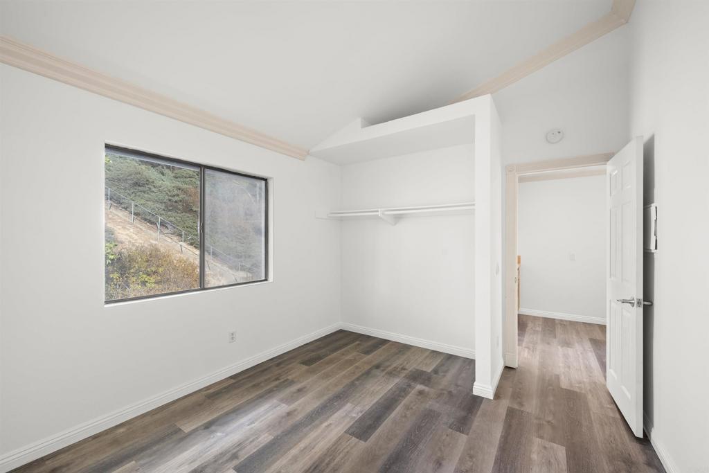 421 Windjammer Circle Chula Vista, CA 91910 - Photo 3 of 17 a view of an empty room with wooden floor and a window