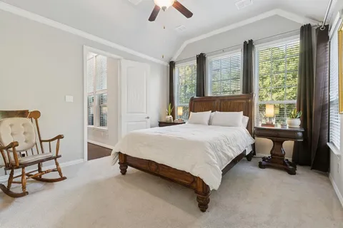 a bedroom with a bed chair and window