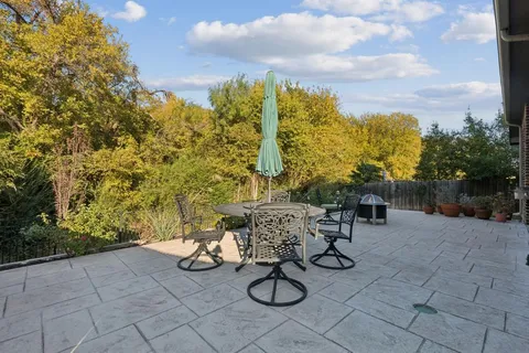 a front view of a house with a yard table and chairs